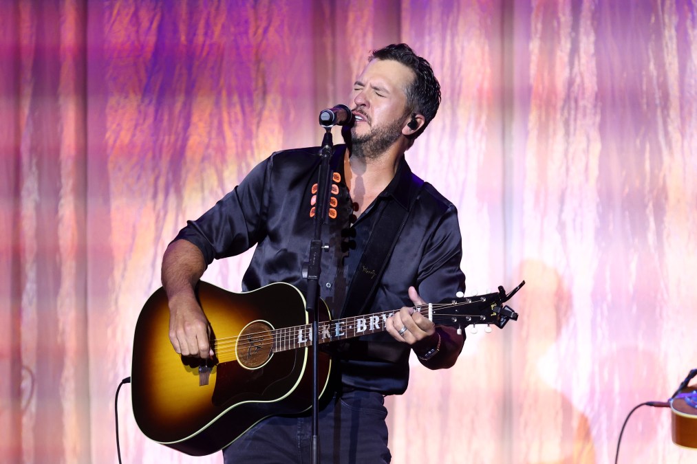 Luke Bryan playing guitar and singing